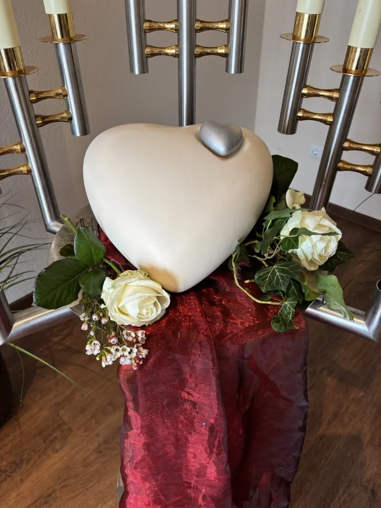 Großes weißes Herz umgeben von weißen Rosen